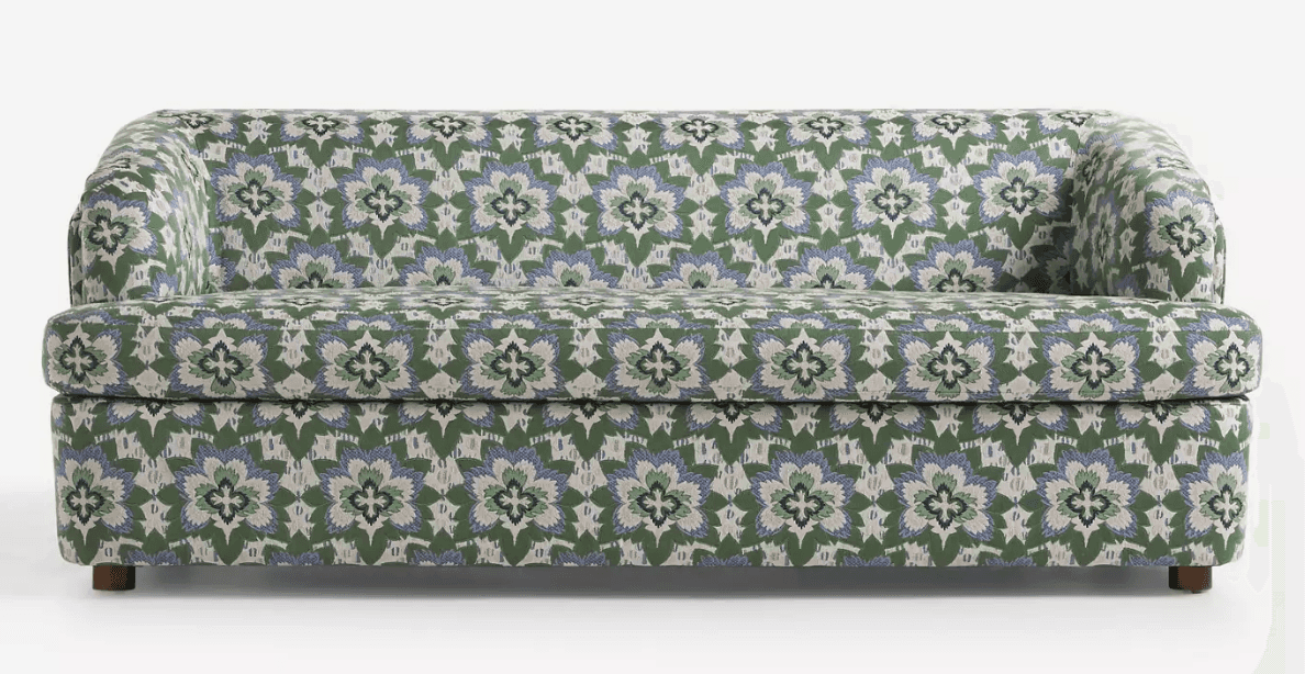 A three-seater sofa with a rounded armrest on the left side. The sofa is upholstered in a fabric wit… — free FBX 3D model