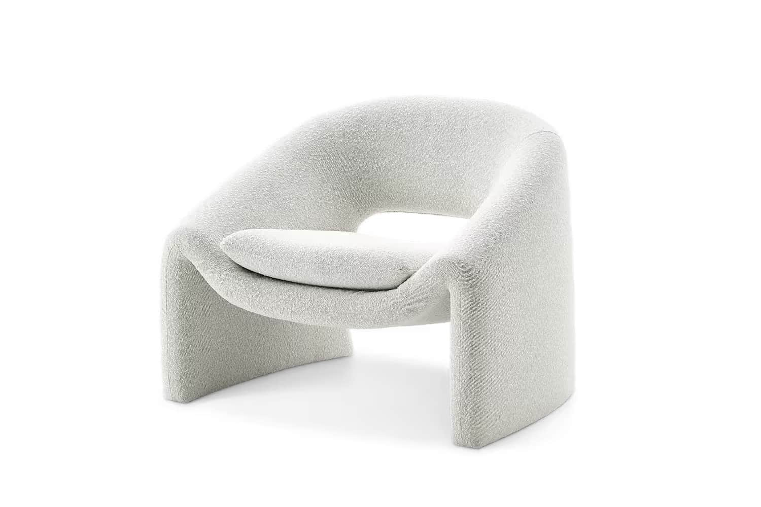 A modern armchair with a distinctive curved silhouette and plush upholstery. The chair features an o… — free GLTF 3D model