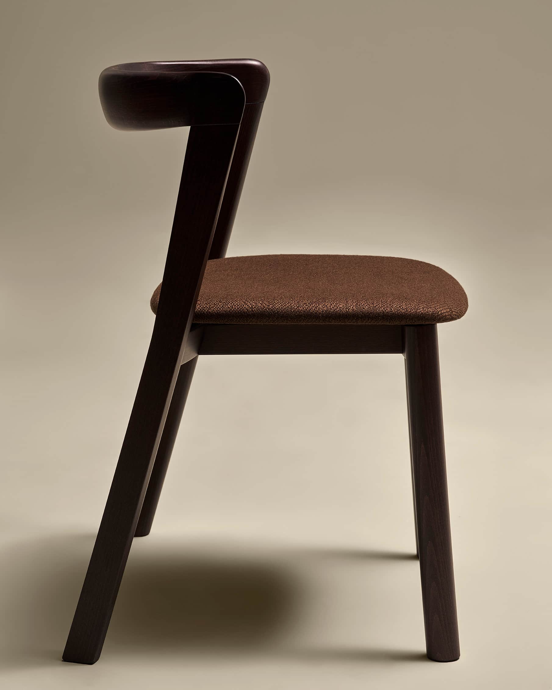 A modern dining chair with a dark wood frame and a fabric-covered seat. The chair features a curved… — 3D model