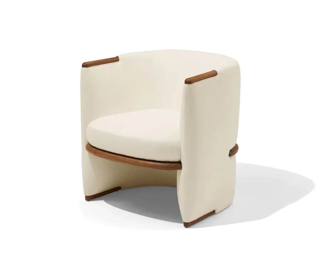 A modern upholstered barrel chair featuring a curved back and integrated arms, covered in cream-colo… — 3D model