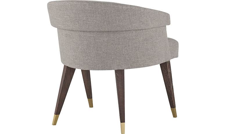 An armchair with a curved backrest and a fabric upholstery. The chair has four tapered wooden legs w… — 3D model