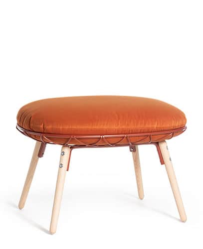 A contemporary round ottoman featuring a plush, burnt orange upholstered cushion. The cushion is cra… — 3D model