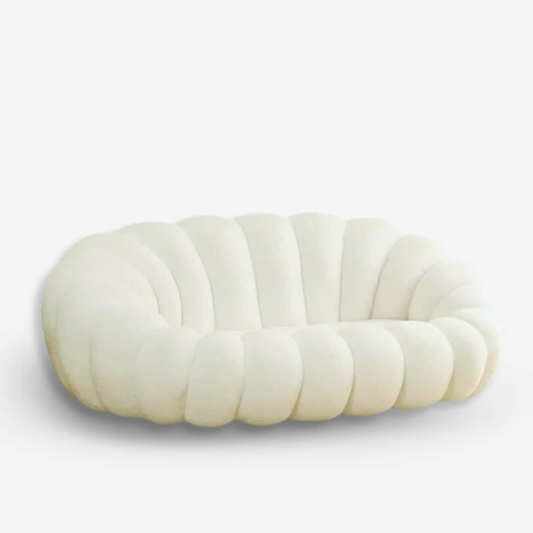 A low-profile, cream-colored upholstered loveseat featuring a distinctive channeled or 'bubble' desi… — 3D model