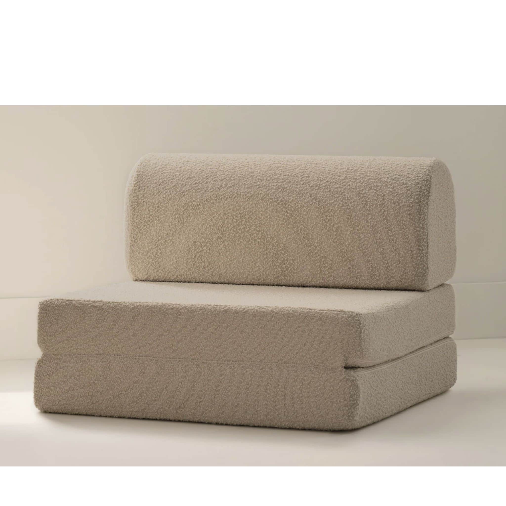 A neutral-toned, beige modular foam chair, constructed from multiple foldable sections, upholstered… — 3D model