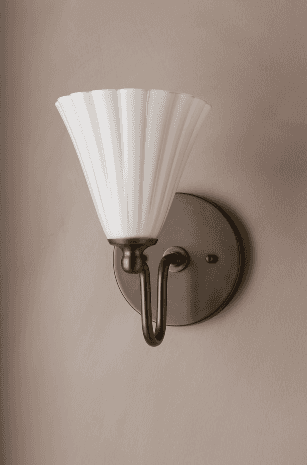 A single wall sconce featuring a conical, fluted shade made of opal glass. The shade is supported by… — 3D model