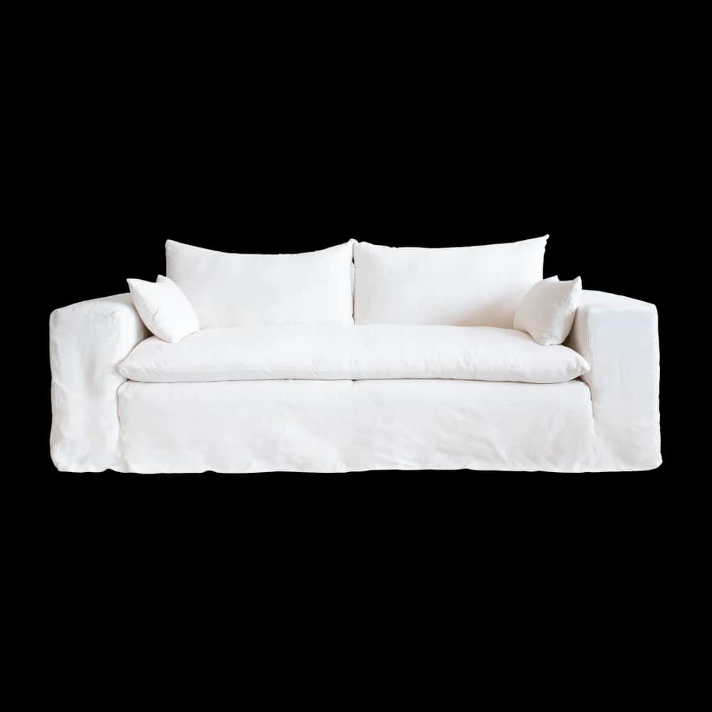 A white slipcovered sofa with two seat cushions and two back cushions. Two small accent pillows are… — 3D model
