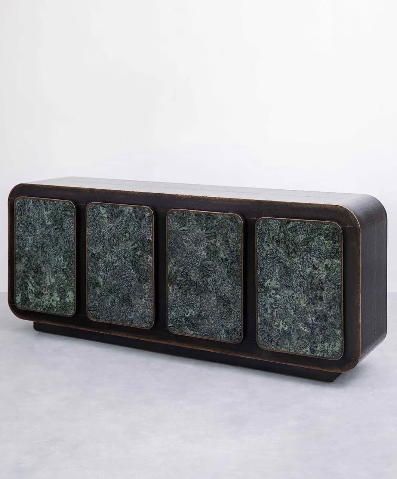 A long, low rectangular cabinet with a dark, patinated metallic finish and four integrated doors fea… — 3D model