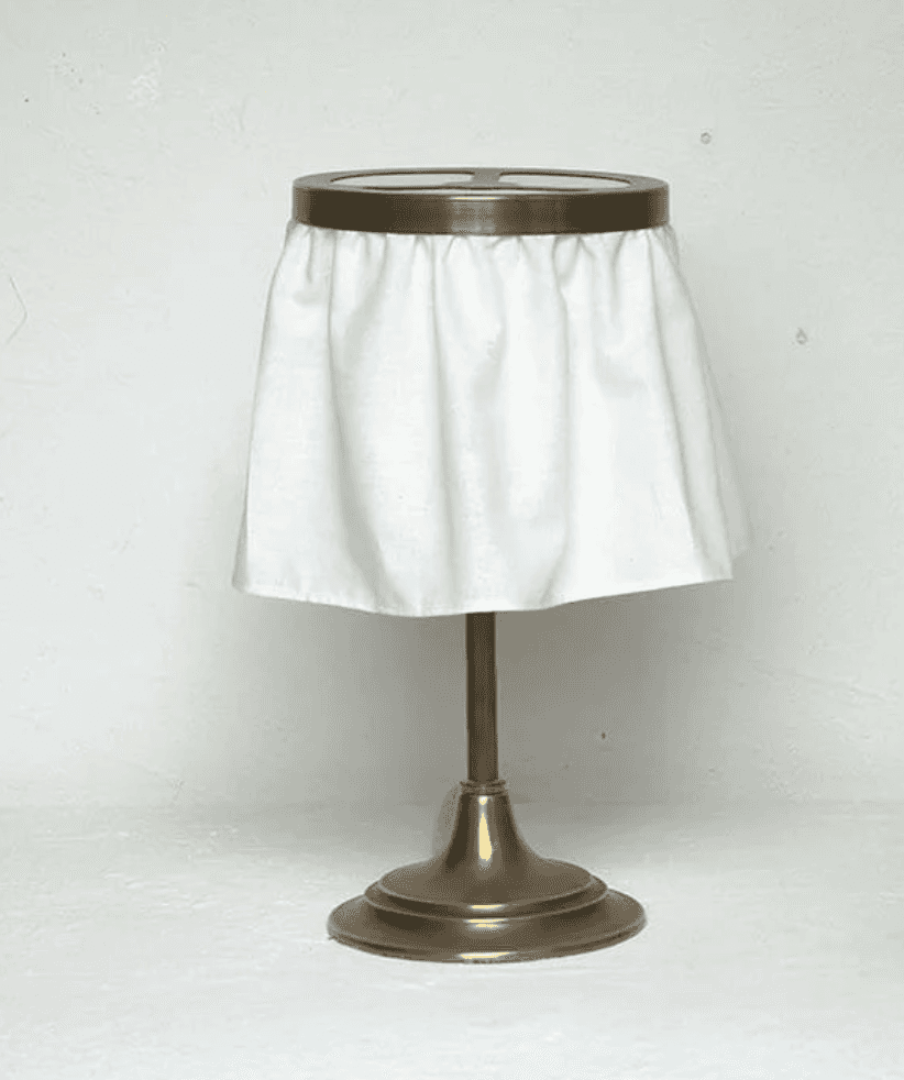 A table lamp featuring an antiqued brass finish pedestal base, a slender brass stem, and a distincti… — 3D model
