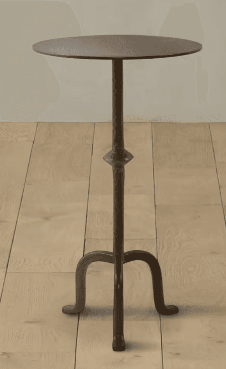 A tall, dark metal pedestal table featuring a round, flat top with a subtle hammered texture. The ce… — 3D model