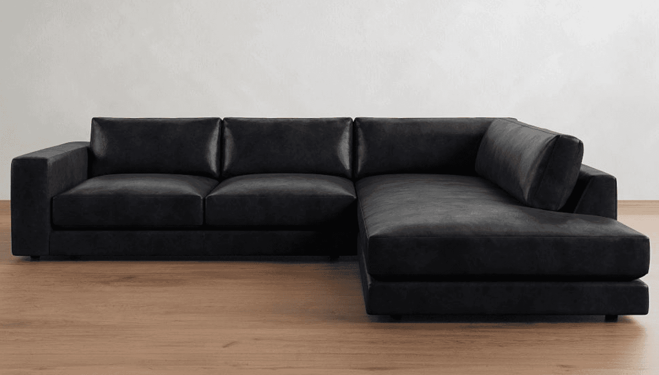 A modern, large black sectional sofa upholstered in what appears to be leather or high-quality faux… — 3D model