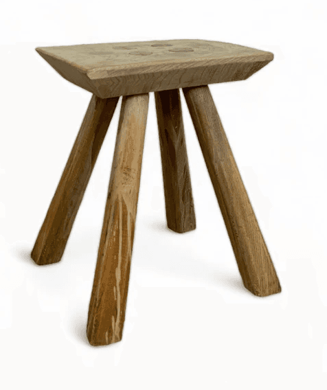 A rustic, three-legged stool with a flat, rectangular top and three roughly shaped legs. The wood ap… — free SKP 3D model