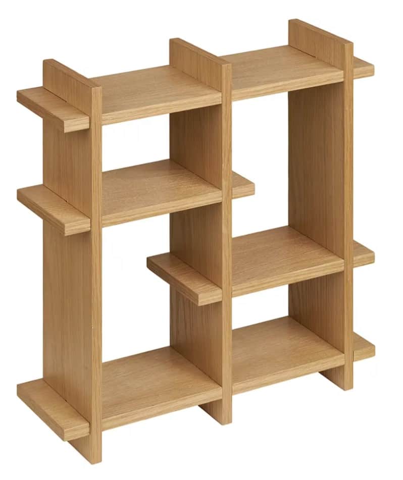 A light wood shelving unit featuring an open-back design and an asymmetric arrangement of shelves an… — 3D model