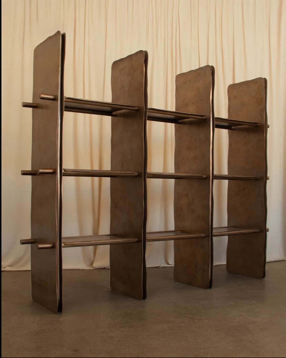 A brown, modular open-back shelving unit featuring three vertical partitions and three horizontal sh… — 3D model