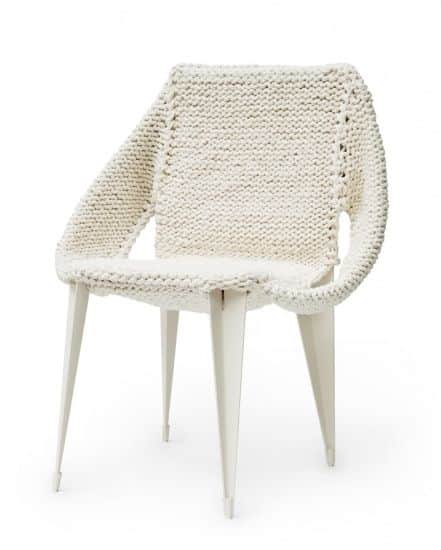 A modern armchair featuring a unique white chunky knitted textile covering the seat, backrest, and i… — 3D model