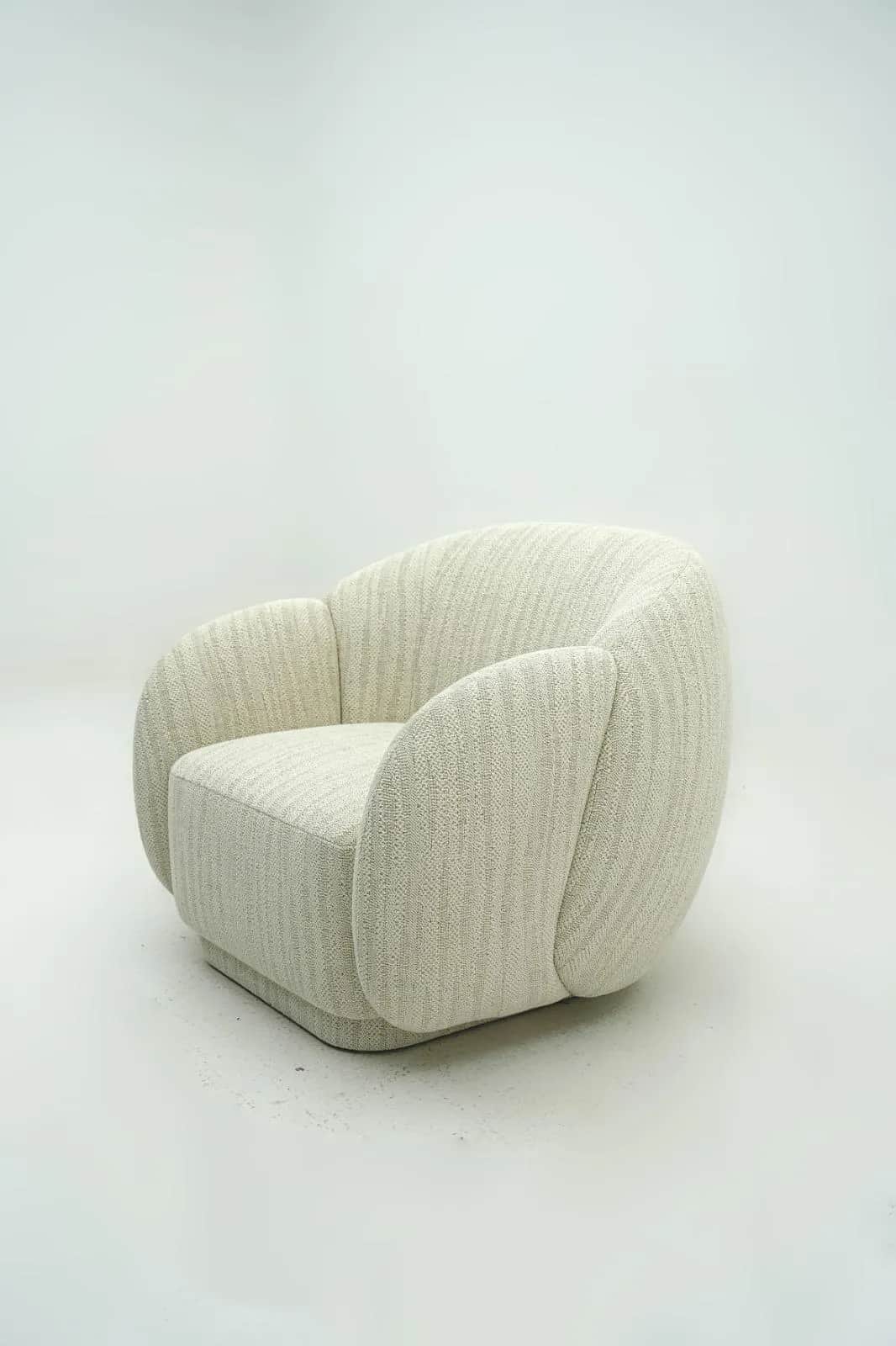 A modern, fully upholstered lounge chair featuring a rounded, sculptural silhouette. The chair has w… — 3D model