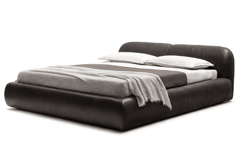 A low-profile upholstered platform bed featuring a padded, integrated headboard and bed frame. The b… — 3D model