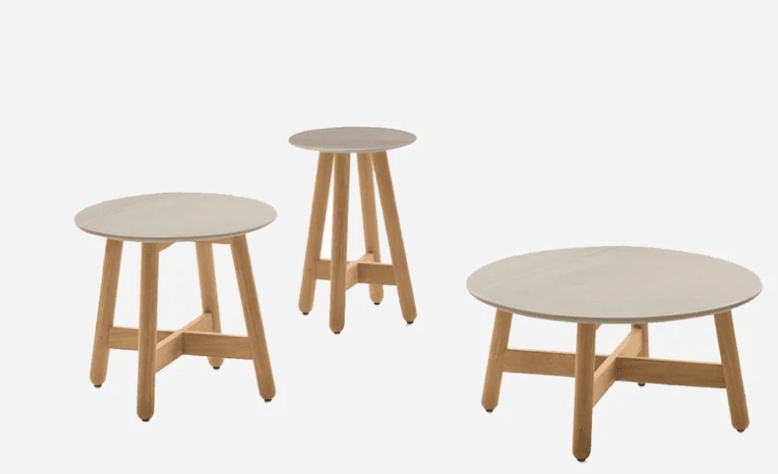 A small round table with a light grey top and three splayed natural wood legs connected by cross-bra… — 3D model