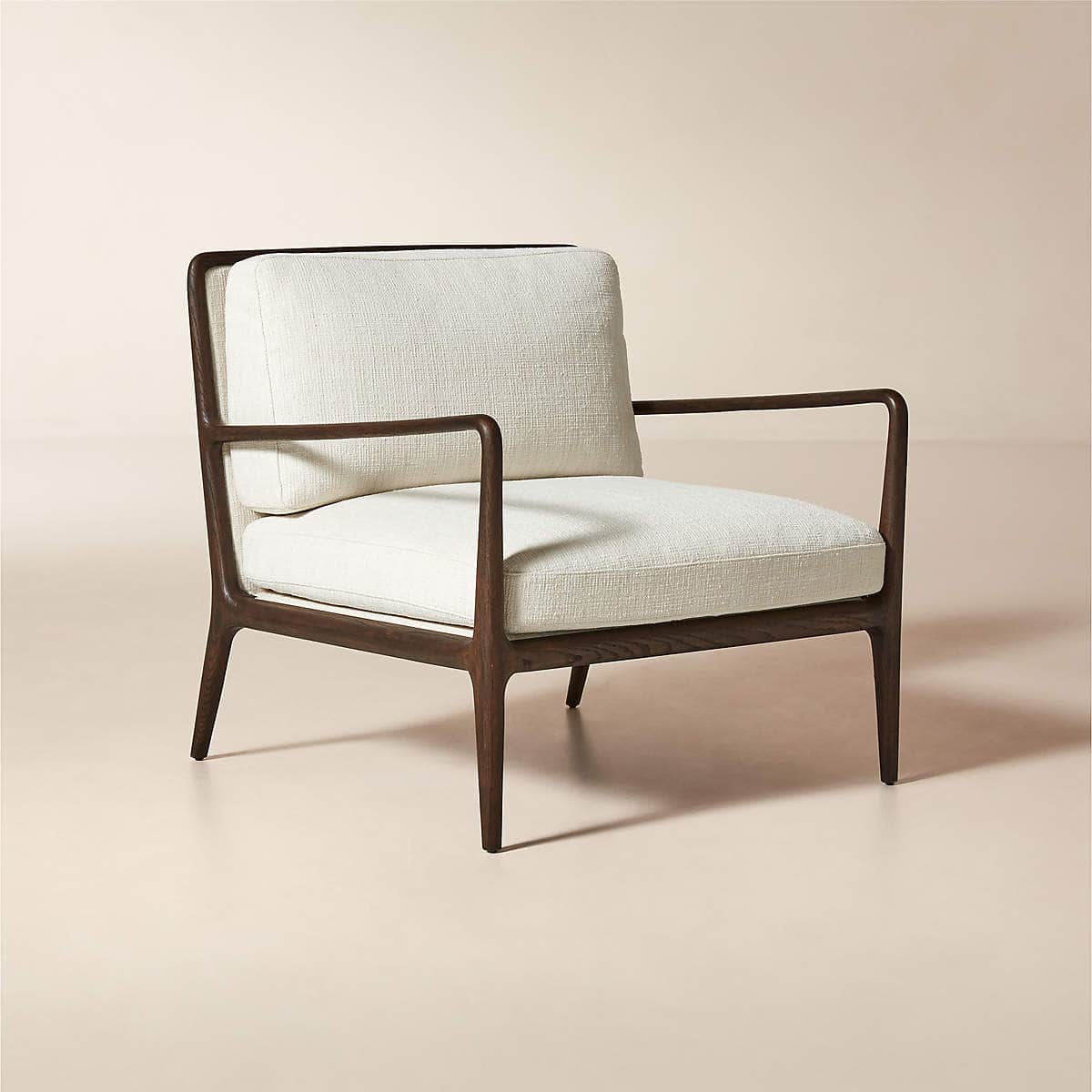 A contemporary lounge chair featuring a dark stained solid wood open frame and thick, removable upho… — free FBX 3D model