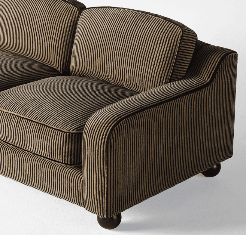 A close-up view of a sofa with a striped upholstery fabric. The sofa features plump cushions, rounde… — 3D model
