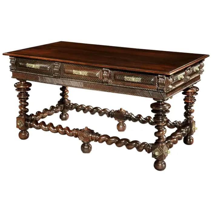 A vintage wooden table with a rectangular top and ornate, carved legs. The apron features intricate… — 3D model