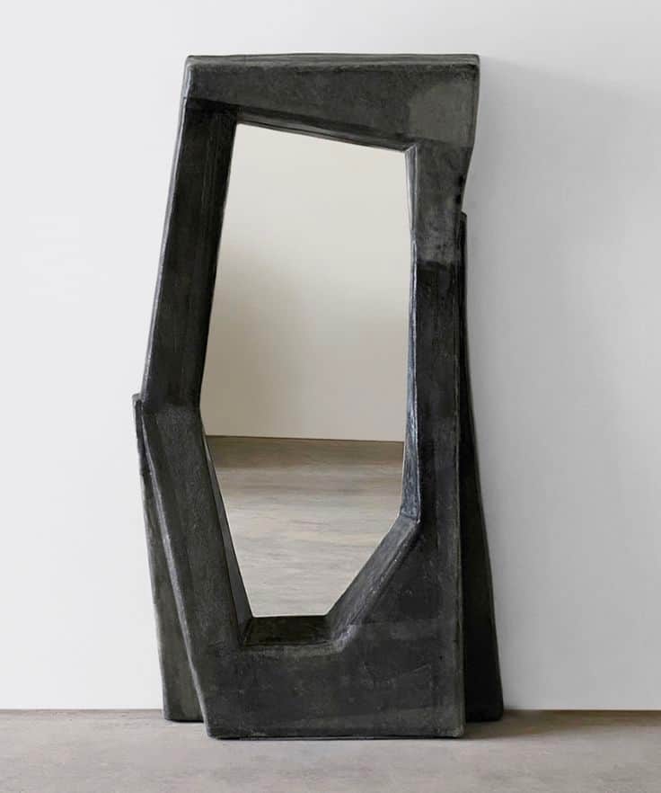 A freestanding mirror with an irregularly shaped frame. The frame has a rough, textured surface and… — 3D model