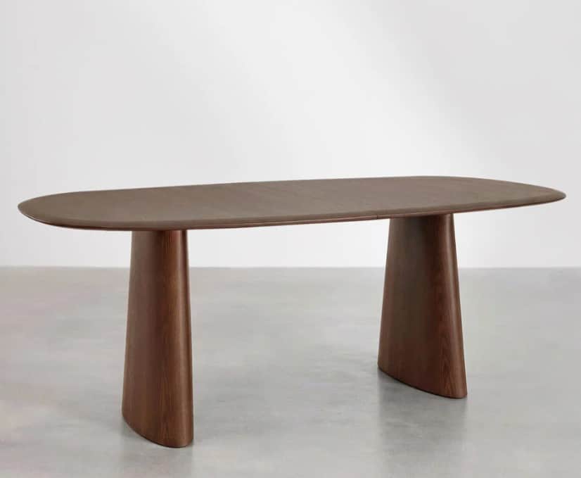 A modern dining table with an elongated, oval-shaped tabletop supported by two distinct, sculptural… — free BLEND 3D model