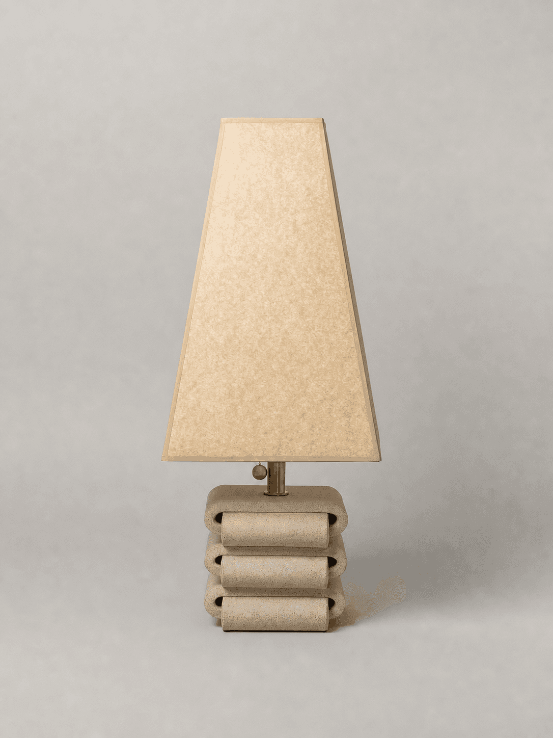 A table lamp with a trapezoidal lampshade and a stacked, rounded base. The base has a textured finis… — free OBJ 3D model