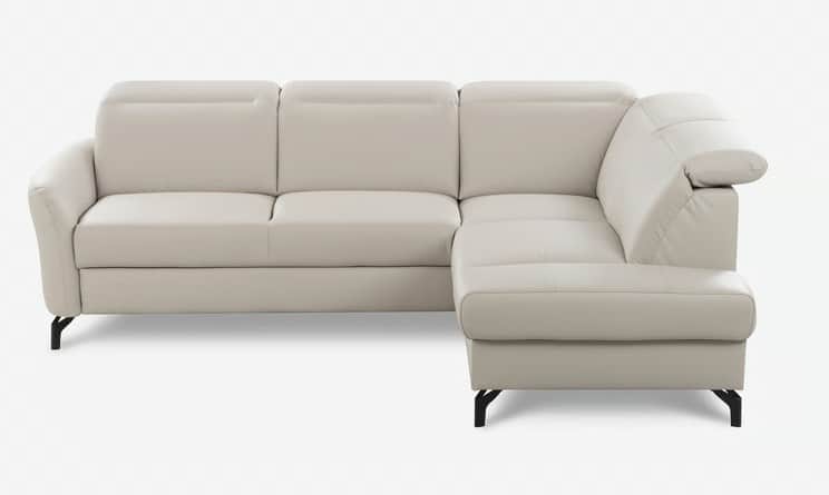 An L-shaped sectional sofa upholstered in a light beige or off-white material, likely leather or fau… — 3D model