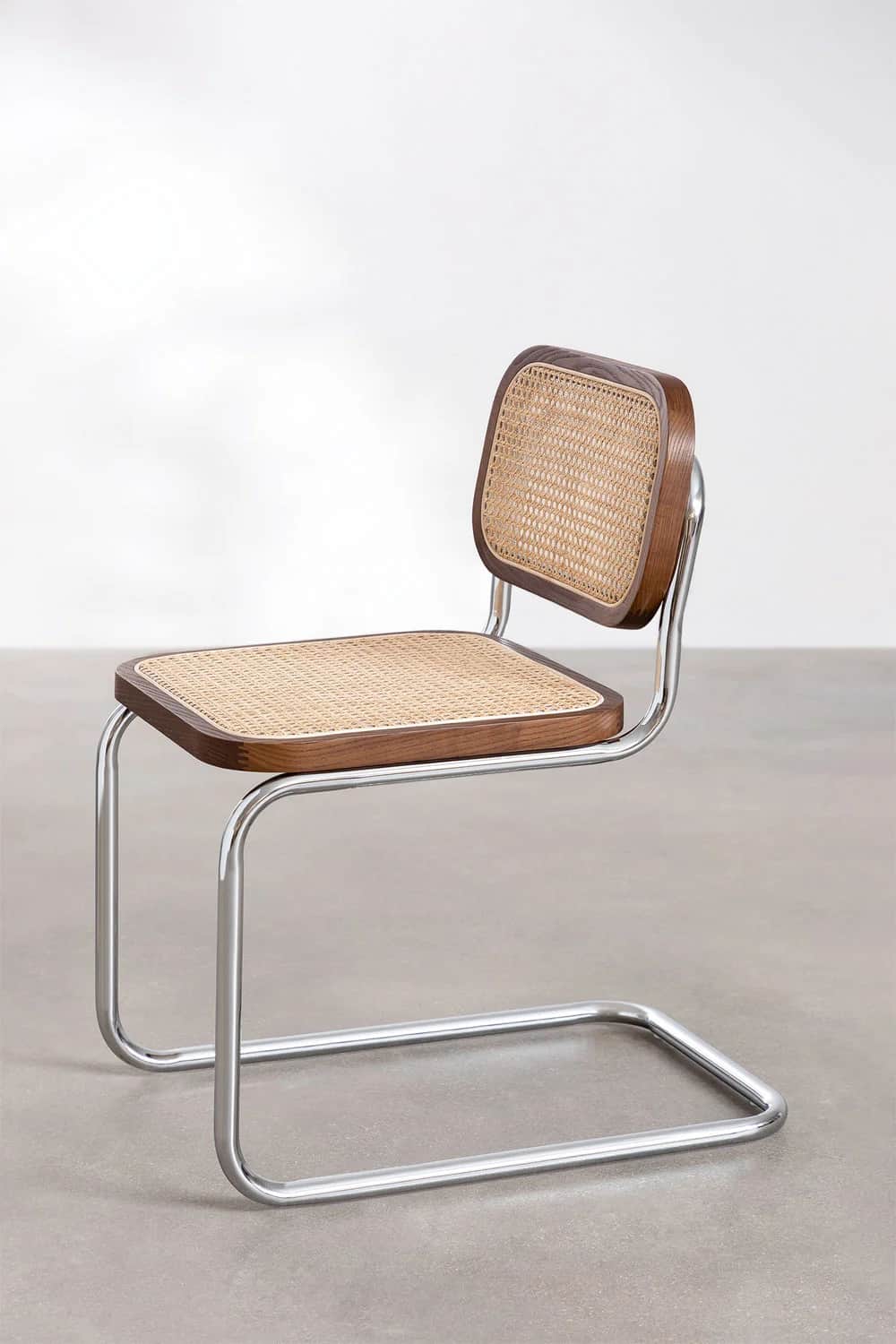 A modern cantilever chair with a tubular chrome frame and a seat and backrest made of wood with cane… — 3D model
