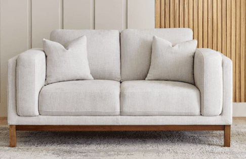 A modern two-seater loveseat featuring light beige fabric upholstery, track arms, two seat cushions,… — 3D model