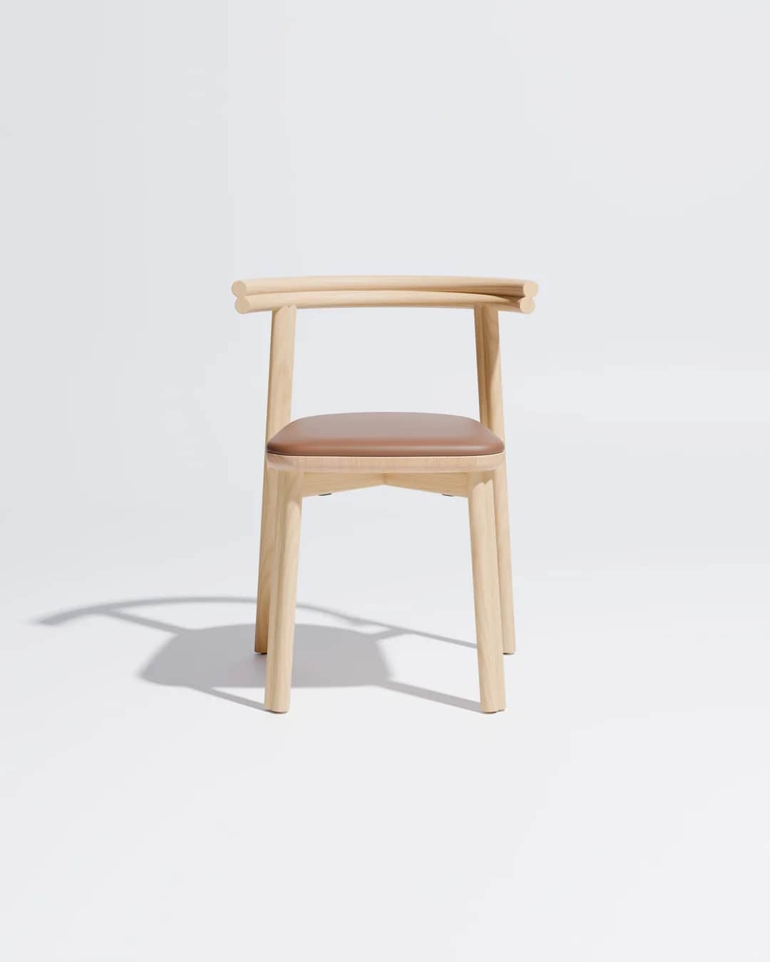 A minimalist chair made from light-colored wood featuring a gently curved backrest that integrates i… — 3D model