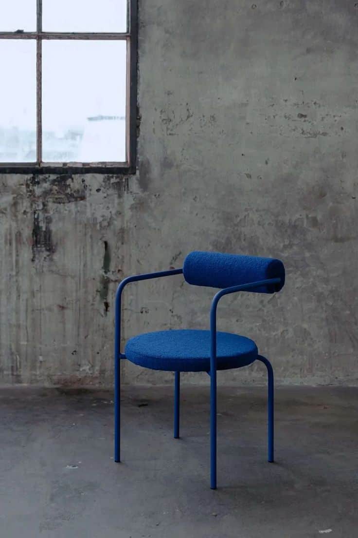 A contemporary accent chair with a circular seat and a cylindrical backrest, supported by a slender… — free OBJ 3D model