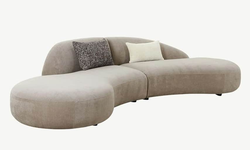 A contemporary curved modular sectional sofa upholstered in a light beige/taupe plush fabric. The so… — 3D model