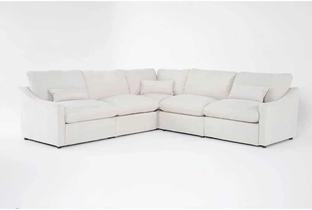 A cream-colored modular sectional sofa upholstered in a soft fabric, featuring plush cushions and a… — 3D model