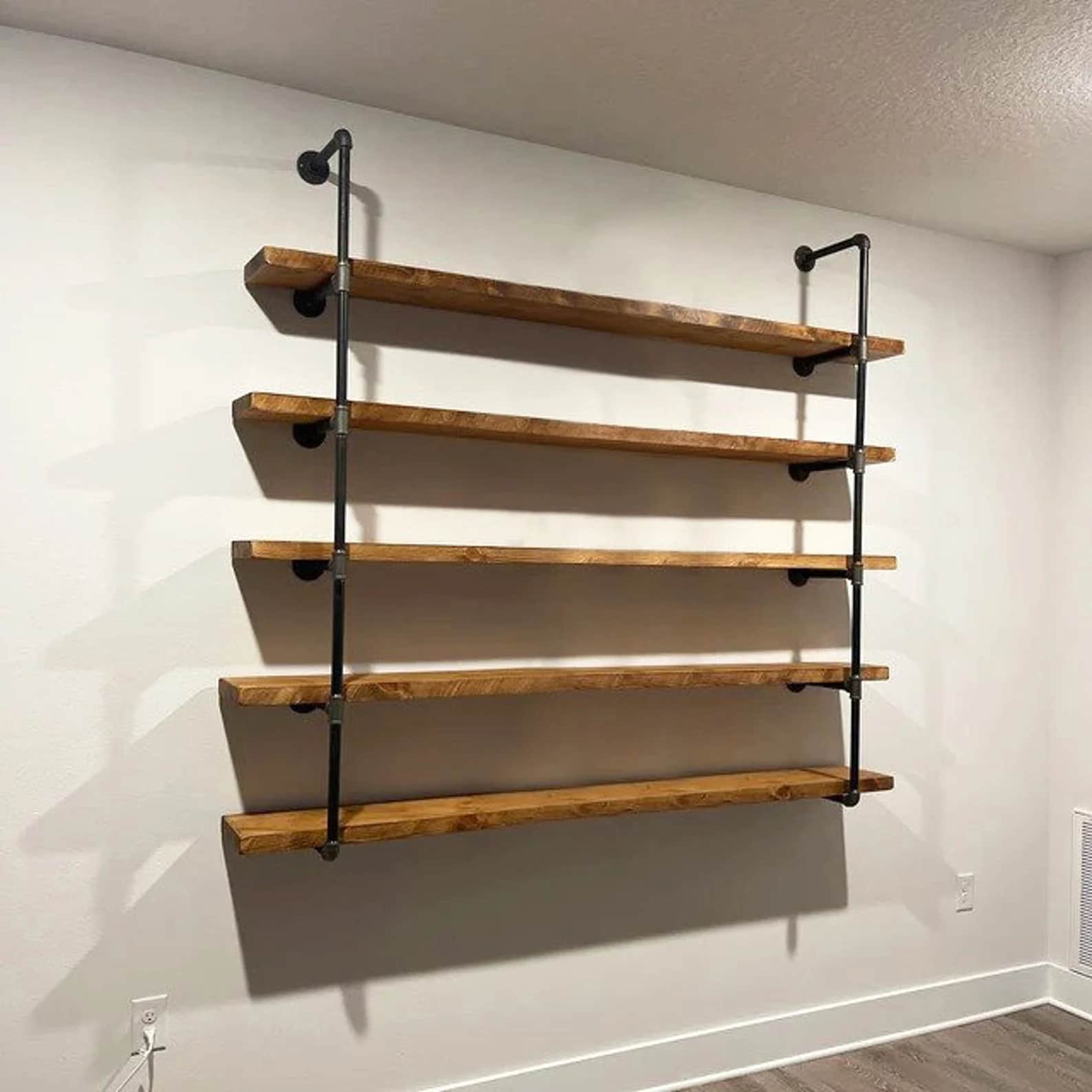 A multi-tiered wall-mounted shelf unit constructed from wooden planks and industrial-style black met… — free BLEND 3D model