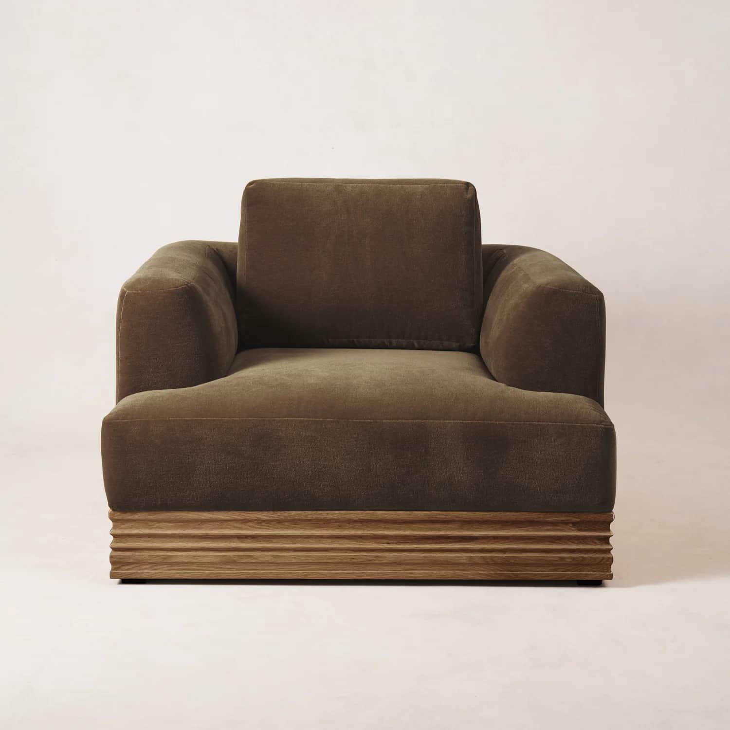 A single-seater armchair with a plush, upholstered body and a distinct wooden base. The armchair fea… — free GLTF 3D model