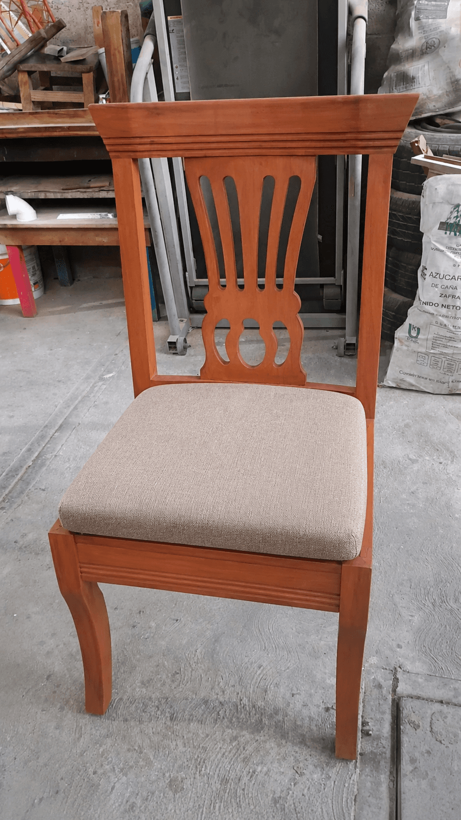 A traditional style armless dining chair featuring a decorative wooden backrest and a light-colored… — 3D model