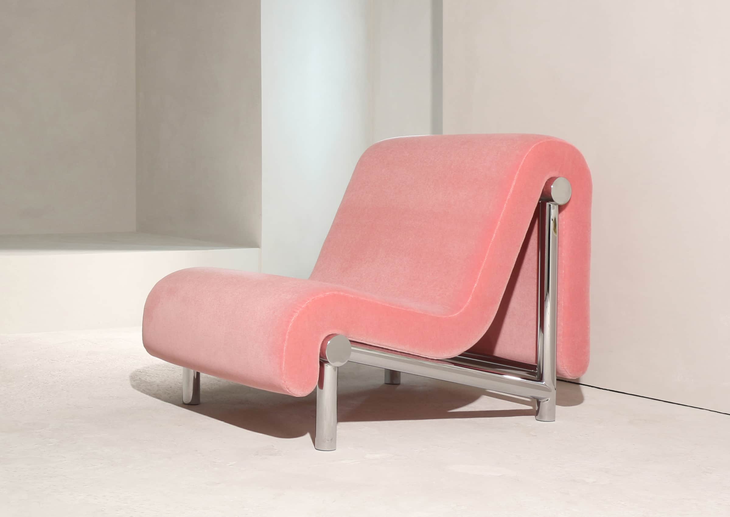 A postmodern lounge chair featuring an S-shaped upholstered form in pink velvet, supported by a poli… — 3D model