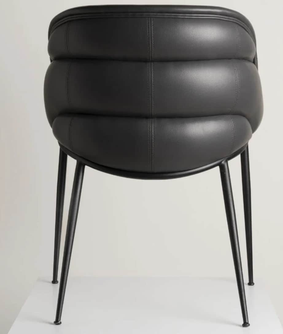 A contemporary chair with a channel-tufted upholstered back and seat, in black, supported by slender… — 3D model