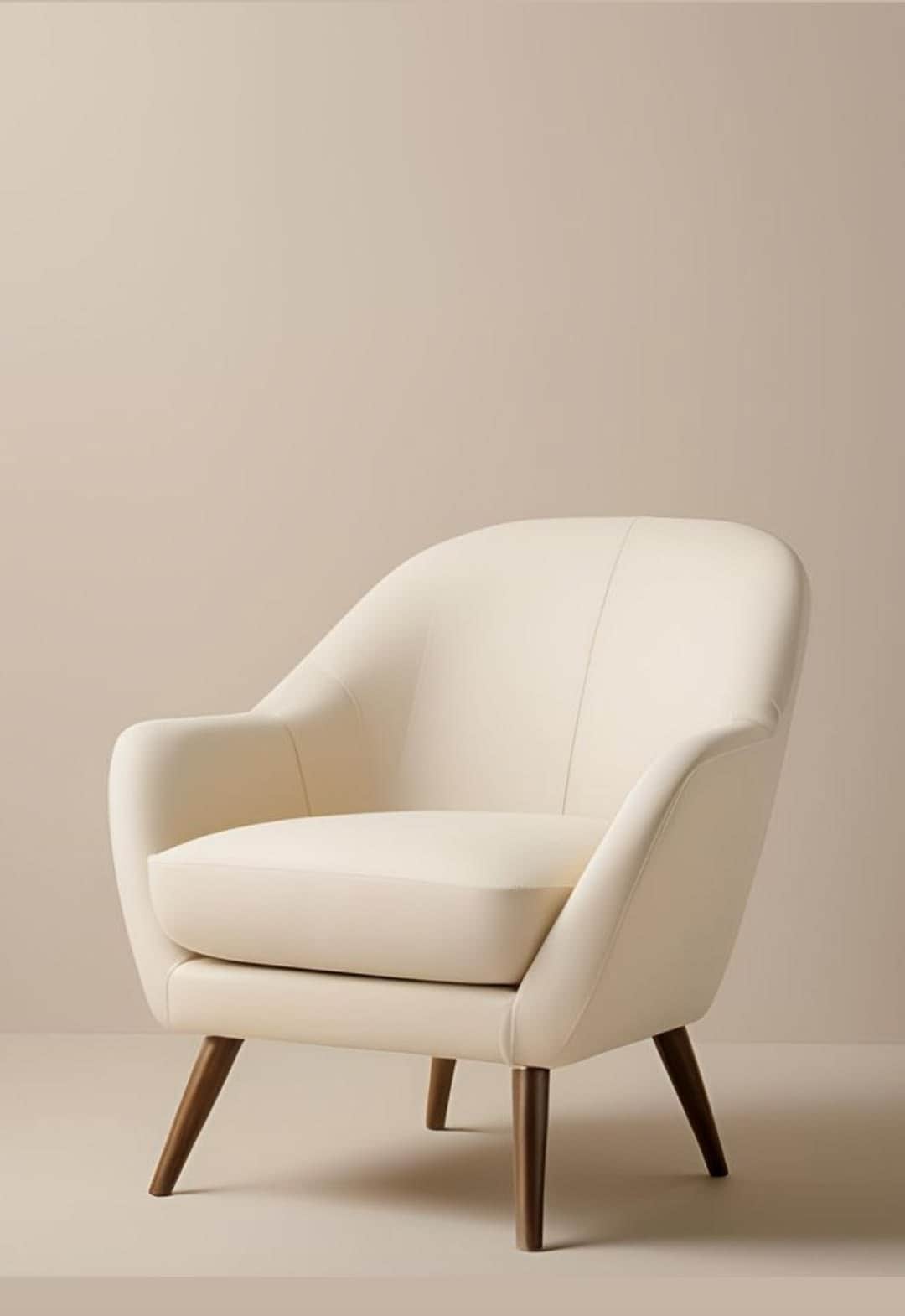 A cream-colored upholstered armchair with a rounded back, integrated arms, a removable seat cushion,… — free FBX 3D model