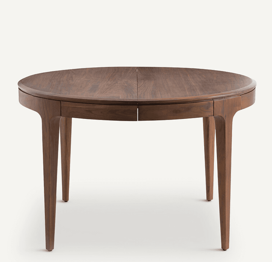 A round dining table with a wooden top and four tapered legs. The tabletop appears to be composed of… — 3D model