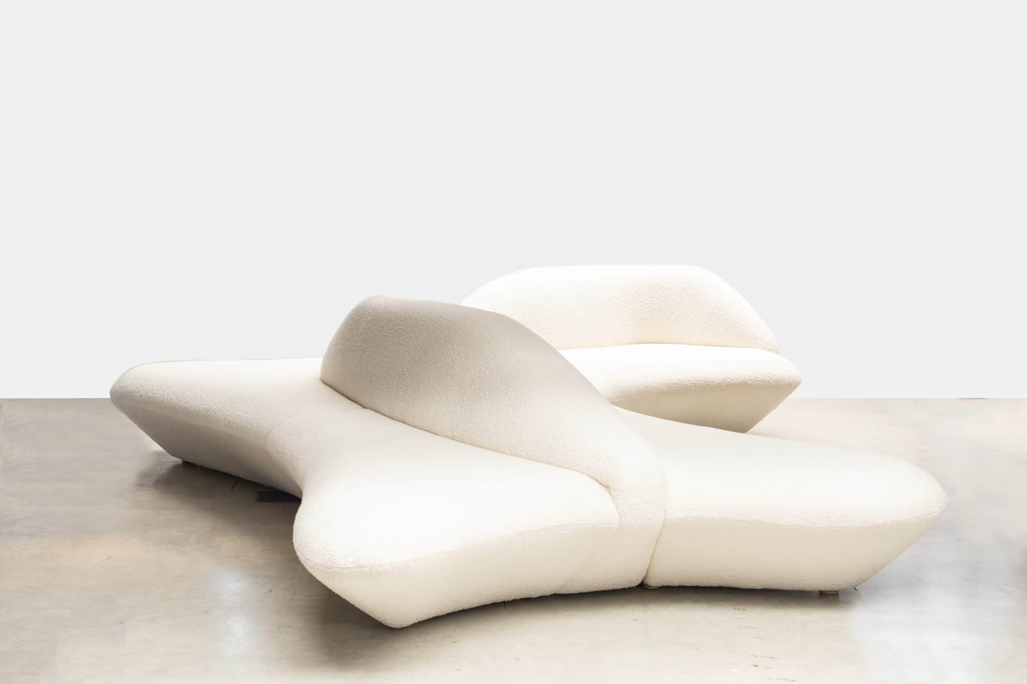 A modular sofa with an organic, curvilinear design, upholstered in a textured boucle fabric. The sof… — free GLTF 3D model