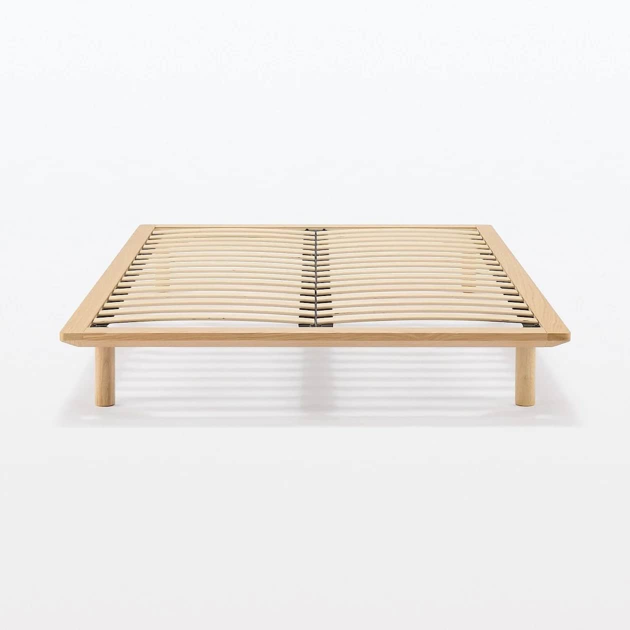 A light-colored wooden bed frame featuring a slatted base for mattress support and four sturdy, cyli… — free SKP 3D model