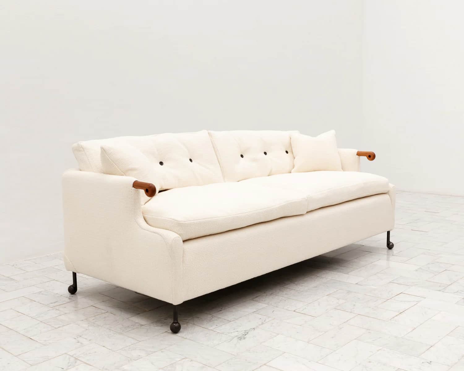 A three-seater sofa featuring a cream-colored, textured fabric upholstery. The design incorporates d… — 3D model