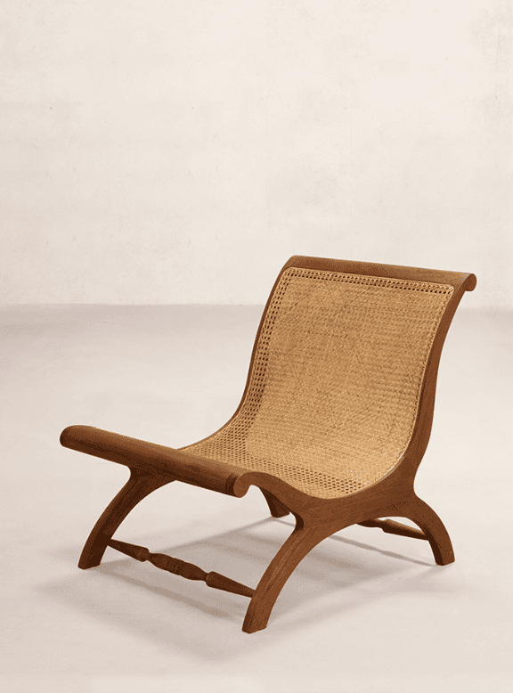 A low-slung, armless lounge chair featuring a dark stained wooden frame and natural cane webbing for… — 3D model
