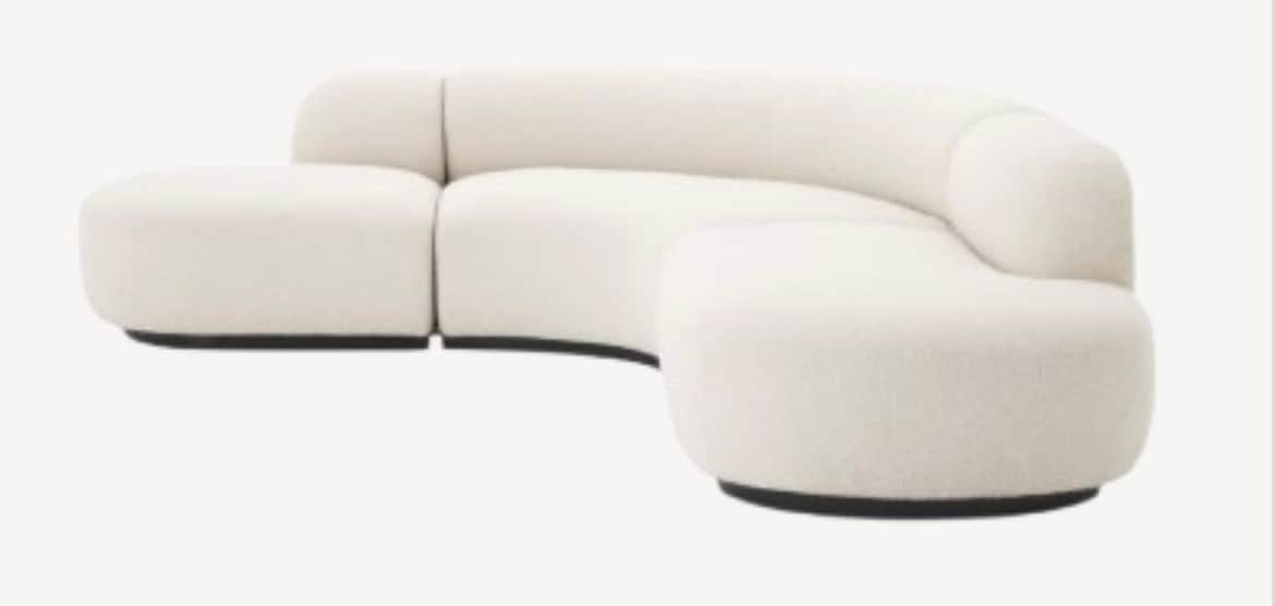 A modern, modular sectional sofa featuring a distinctive curved form and upholstered in a tactile, o… — 3D model