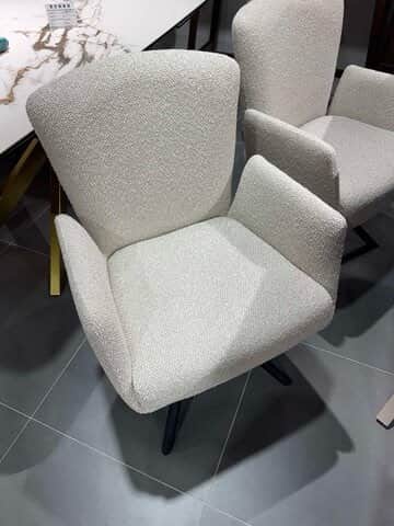 An upholstered armchair featuring a rounded backrest, integrated armrests, and splayed, tapered legs… — free OBJ 3D model