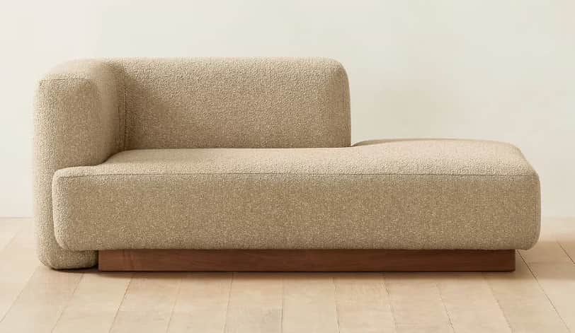 A modern upholstered chaise lounge featuring a single integrated left armrest and a low-profile desi… — 3D model