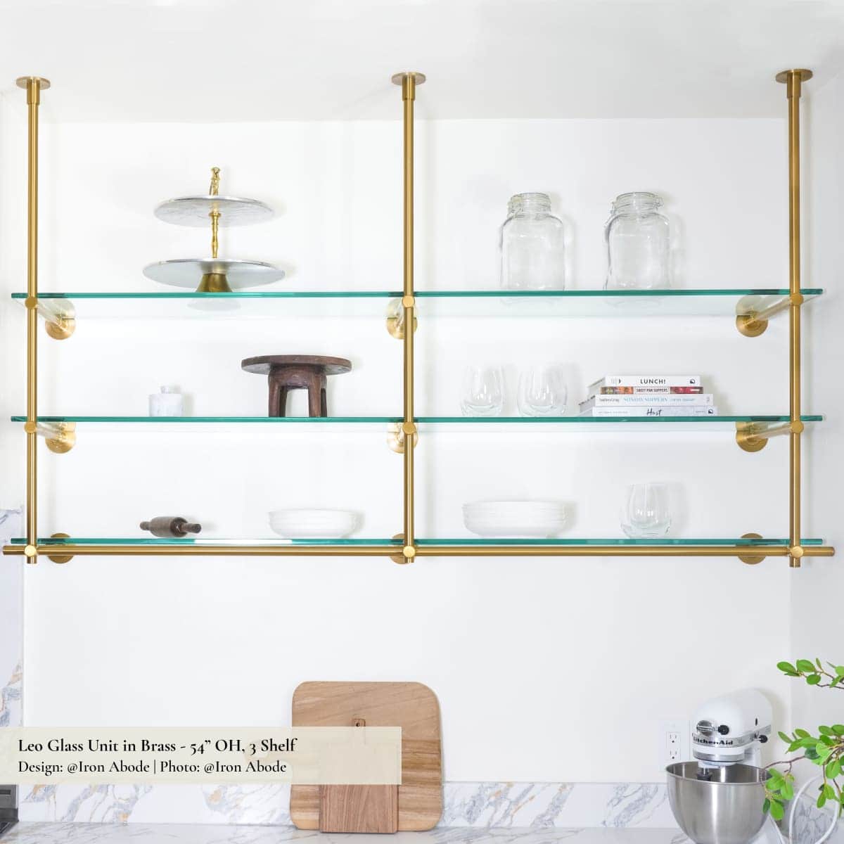 A three-tier shelving unit suspended from the ceiling. It features transparent glass shelves support… — 3D model