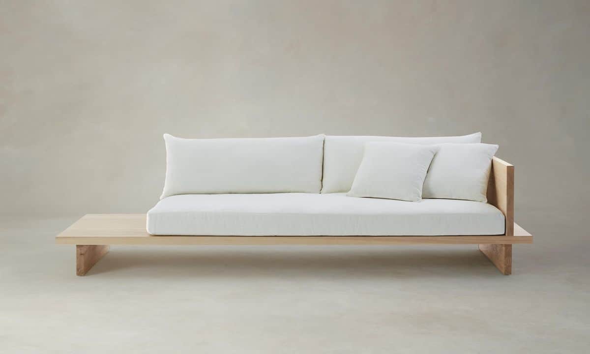 A low-profile sofa featuring a wooden base and frame with a wide, integrated side table. The seating… — free GLTF 3D model